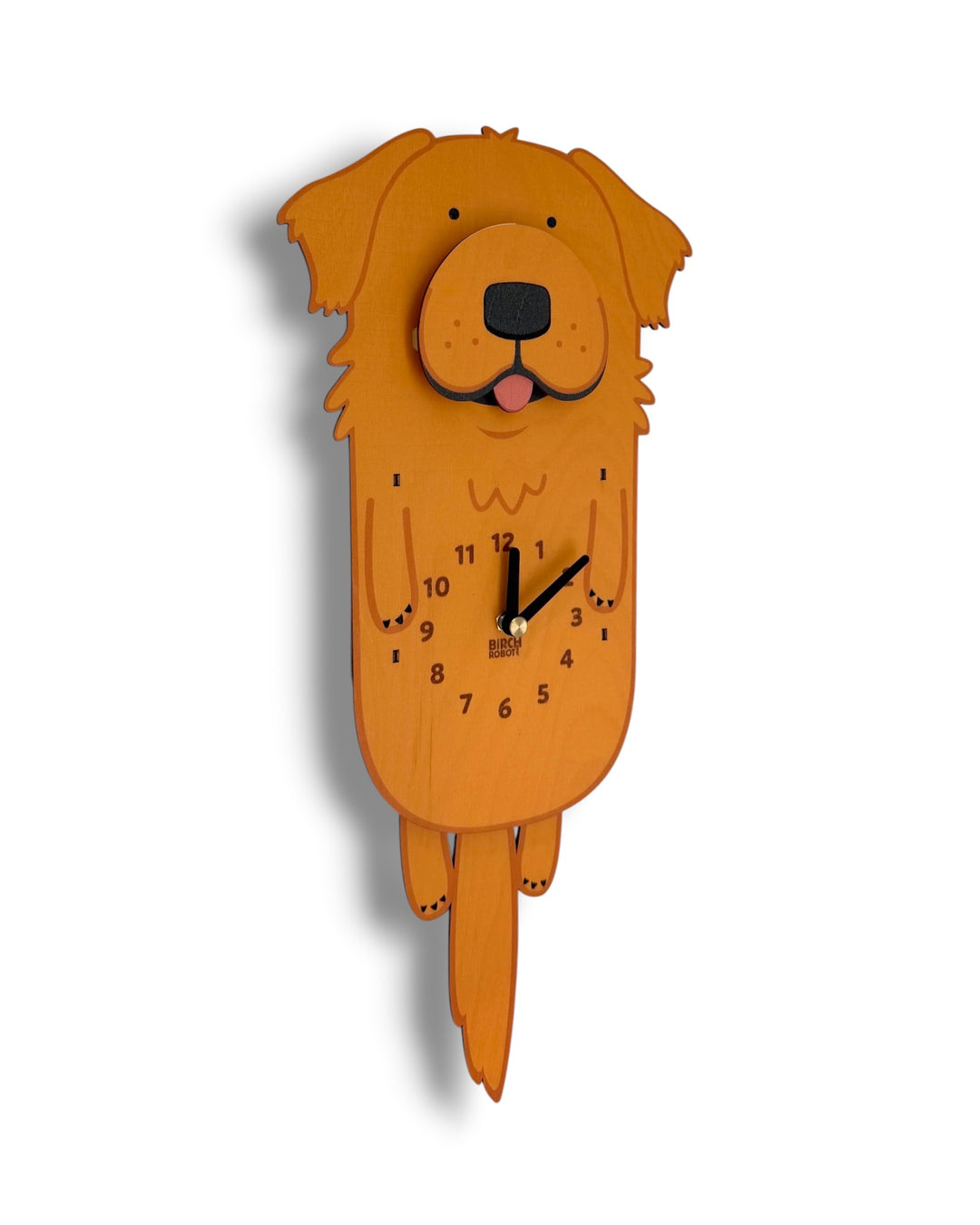 A golden retriever wall clock made from layered orange-brown wood, featuring a cartoon dog face and black clock hands on a plain white background.